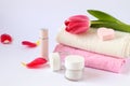 Scarlet tulip on terry towels, body care products, heart-shaped sponge on a white background, side view-the concept of taking care