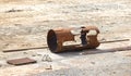 Scarred old rusty piece of metal pipe lies on the sand Royalty Free Stock Photo