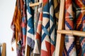 scarves with geometric designs hanging on a wooden ladder rack Royalty Free Stock Photo