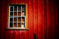 Scary abandoned house with old peeling red wooden wall and grunge broken window under dramatic lighting Royalty Free Stock Photo