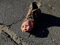 scary and broken doll face with one blue eye along with an old brown boot Royalty Free Stock Photo