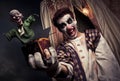 Scary clown holding a Jack-in-the-box toy Royalty Free Stock Photo