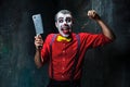 The scary clown holding a knife on dack. Halloween concept Royalty Free Stock Photo