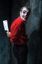 The scary clown holding a knife on dack. Halloween concept Royalty Free Stock Photo