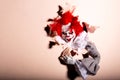 Scary clown killer breaks through the wall. horror. Halloween concept Royalty Free Stock Photo