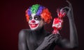 Scary clown with spooky makeup and more candy Royalty Free Stock Photo