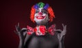 Scary clown with spooky makeup and more candy Royalty Free Stock Photo