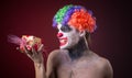 Scary clown with spooky makeup and more candy Royalty Free Stock Photo