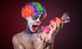 Scary clown with spooky makeup and more candy Royalty Free Stock Photo