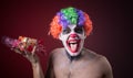 Scary clown with spooky makeup and more candy Royalty Free Stock Photo