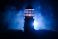 Scary dark ominous lighthouse behind a red fire background. Lighthouse at dusk/ Sunset Light House/ Light house at sunset. Decorat Royalty Free Stock Photo