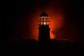 Scary dark ominous lighthouse behind a red fire background. Lighthouse at dusk/ Sunset Light House/ Light house at sunset. Decorat Royalty Free Stock Photo