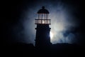 Scary dark ominous lighthouse behind a red fire background. Lighthouse at dusk/ Sunset Light House/ Light house at sunset. Decorat Royalty Free Stock Photo