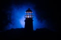 Scary dark ominous lighthouse behind a red fire background. Lighthouse at dusk/ Sunset Light House/ Light house at sunset. Decorat Royalty Free Stock Photo