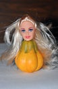 Scary doll with a pumpkin torso. Halloween Royalty Free Stock Photo