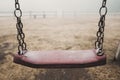 Scary empty swing at the park with fog in backgroind. Creepy scenic place. Sadness and depression. Ukraine war desolation and