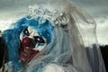 Scary evil clown in a bride dress