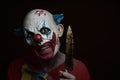 Scary evil clown with a knife Royalty Free Stock Photo