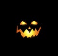 Scary and evil pumpkin jack o lantern glowing face on black background Royalty Free Stock Photo