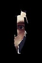 Scary eye of a man spying through a hole in the wall Royalty Free Stock Photo