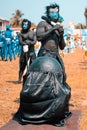 A scary face masked man looking like an African god performing at a festival in Africa Ghana