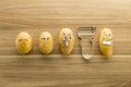 Scary face potatoes and peeler on wooden cutting board Royalty Free Stock Photo