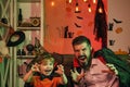 Scary family for Halloween. Postcard. Father and son scare with their hands. A terrible tradition. Family celebration