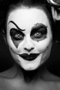 A scary female clown staring