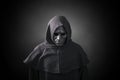 Scary figure in hooded cloak with mask Royalty Free Stock Photo