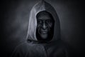 Scary figure in hooded cloak with mask Royalty Free Stock Photo