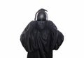 Scary figure in hooded cloak with mask in hands Royalty Free Stock Photo