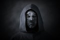 Scary figure in hooded cloak with mask Royalty Free Stock Photo