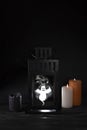 Scary ghost in an old lantern, restless spirit and candles on a black background, halloween concept Royalty Free Stock Photo