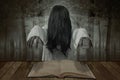 Scary ghost woman standing with a book on the table in the forest Royalty Free Stock Photo
