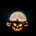 Scary glowing pumpkin with a full moon on a black background. Halloween wallpaper at night Royalty Free Stock Photo