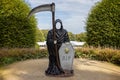 Scary Grim Reaper figure with large scythe on display for Halloween at Alnwick Gardens, Alnwick, Northumberland, UK Royalty Free Stock Photo