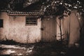 Scary grunge background in horror style, closed door to a dangerous barn of an old crumbling house in a night forest, an Royalty Free Stock Photo