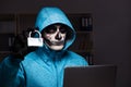 The scary hacker hacking security firewall late in office Royalty Free Stock Photo