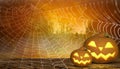 Scary halloween background with grinning pumpkins and a cobweb