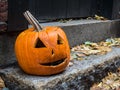 Scary Halloween Pumpkin Face on a doorstep Royalty Free Stock Photo