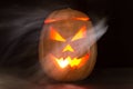 Scary halloween pumpkin jack-o-lanterns with a scar isolated on black Royalty Free Stock Photo