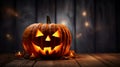 Scary halloween pumpkin on wooden planks In A Spooky At Night. Candle lit Halloween Pumpkins. Royalty Free Stock Photo