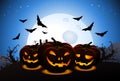 Scary halloween wallpaper with carved pumpkins and scary bats Royalty Free Stock Photo