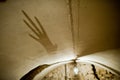 Scary hand shadow on the ceiling in the haunted castle.