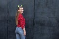 Young woman with devils horn on head