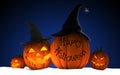 Scary Jack O Lantern halloween pumpkins wearing black witch hat Royalty Free Stock Photo