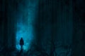 Scary lonely ghost or alien in the paranormal foggy forest