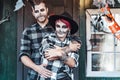 Scary love romantic family couple man,woman celebrating halloween.Terrifying black skull half-face makeup,witch costumes