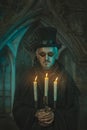 Scary man with candles in the candelabra. Royalty Free Stock Photo