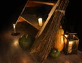 Scary occult still life with witch broomstick, pumpkins and candles by staircase Royalty Free Stock Photo